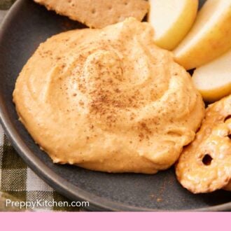 Pinterest graphic of a plate with a dollop of pumpkin dip with crackers and apple slices.