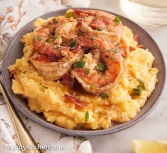 Pinterest graphic of a bowl of shrimp and grits with a glass of wine in the background.