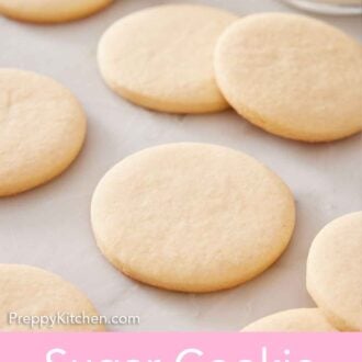 Pinterest graphic of multiple sugar cookies on a marble surface, some are slightly stacked on others.