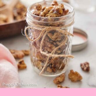 Pinterest graphic of a mason jar of toasted walnuts with a twine bow.