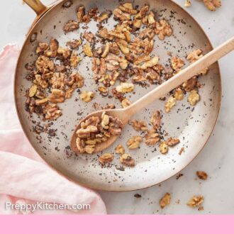 Pinterest graphic of an overhead view of a skillet of toasted walnuts.