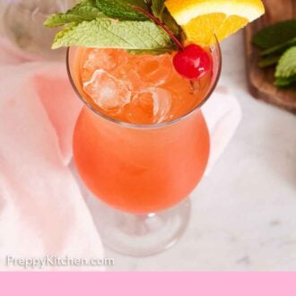 Pinterest graphic of a glass of zombie cocktail garnished with mint, maraschino cherry, and orange.