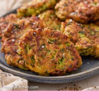 Pinterest graphic of a close view of zucchini fritters on a platter.