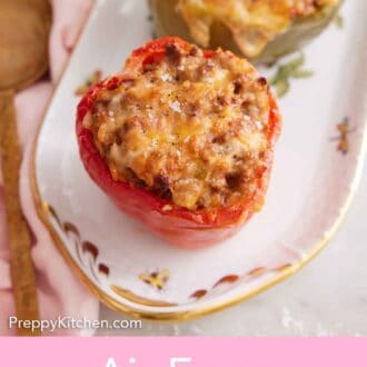 Pinterest graphic of a platter of three air fryer stuffed peppers.