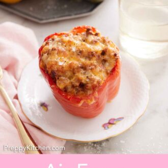 Pinterest graphic of a plate with a serving of air fryer stuffed pepper with a glass of water behind it.