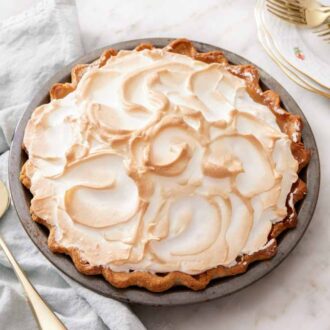 A baking dish of butterscotch pie with a pie spatula on the side.