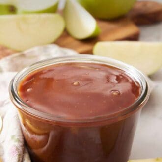 Pinterest graphic of a jar of caramel sauce with some chopped apples in the background.