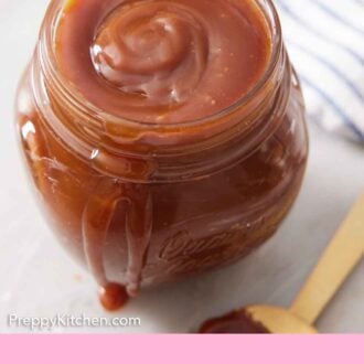 Pinterest graphic of a slightly overhead view of a jar of caramel sauce with a spoon on the side.