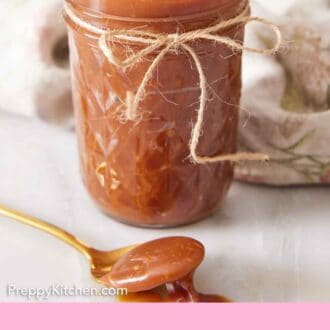 Pinterest graphic of a jar of caramel sauce with a string bow tied onto it with a spoonful of sauce in front.