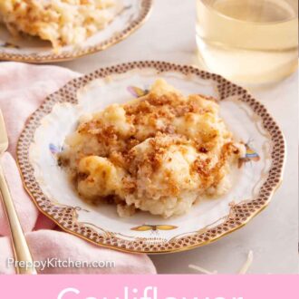 Pinterest graphic of a plate of cauliflower gratin with a glass of wine and second plate in the background.