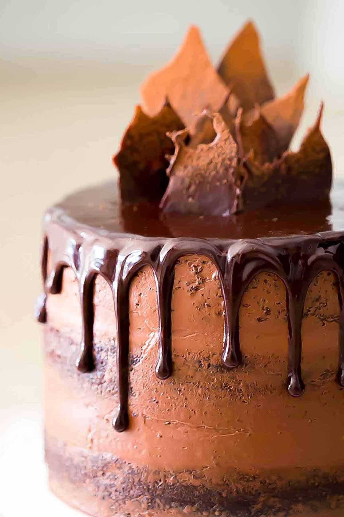 A cake with chocolate dripping over the top.