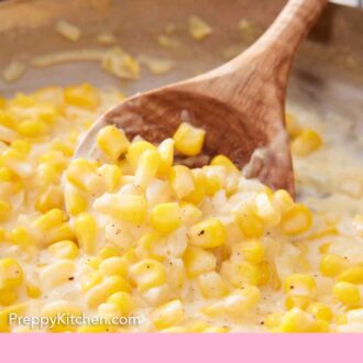 Pinterest graphic of a wooden spoon scooping creamed corn in a skillet.