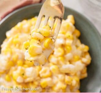 Pinterest graphic of a fork lifting up a bite of creamed corn from a plate.