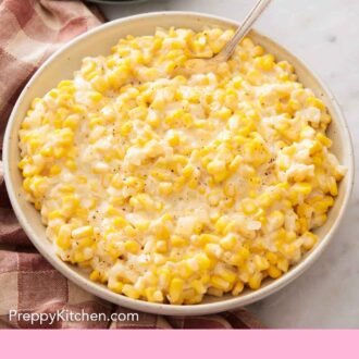 Pinterest graphic of a serving bowl of creamed corn with a spoon tucked in.