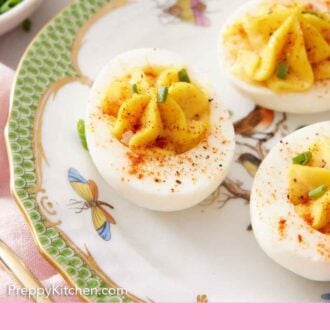 Pinterest graphic of a plate with three deviled eggs topped with paprika.