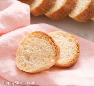 Pinterest graphic of two slices of French bread on a pink napkin with additional sliced bread in the background.