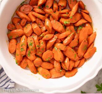 Pinterest graphic of an overhead view of a bowl of glazed carrots topped with chopped parsley.