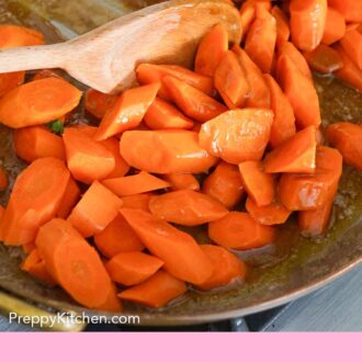Pinterest graphic of a skillet of glazed carrots stirred in a skillet with a wooden spoon.