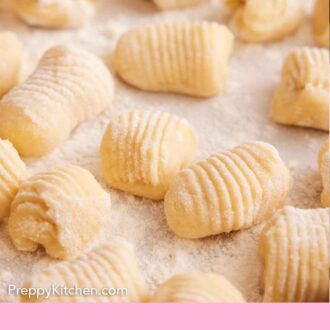 Pinterest graphic of multiple pieces of rolled gnocchi dough coated in a light layer of flour.