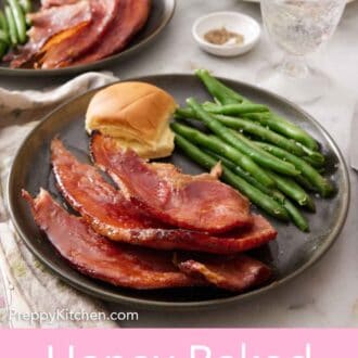 Pinterest graphic of a plate with a serving of honey baked ham with bread and green beans. A second plated serving in the background along with a platter with the ham.
