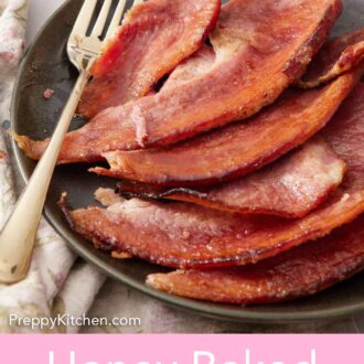 Pinterest graphic of a plate with a pieces of honey baked ham with a fork. A plate with bread and ham on it in the background.