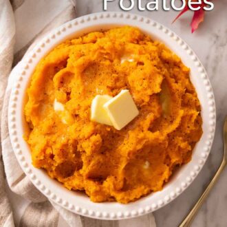 Pinterest graphic of a bowl of mashed sweet potatoes with knobs of butter on top. Linen napkin and some leaves on the side.