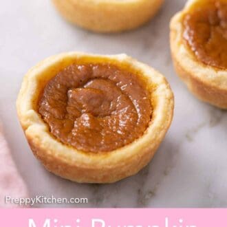 Pinterest graphic of three mini pumpkin pies on a marble surface.