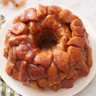 A plate of monkey bread with sauce drizzling of it.