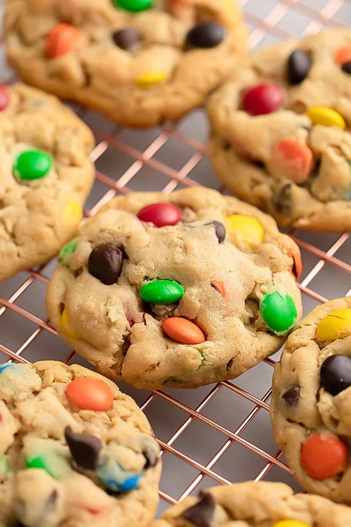 A cooling rack with monster cookies.