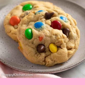 Pinterest graphic of two monster cookies on a plate.