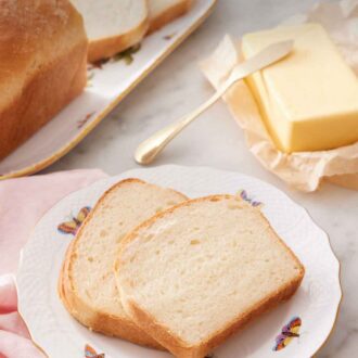Pinterest graphic of a plate with two slices of potato bread with butter and the rest of the bread in the background.