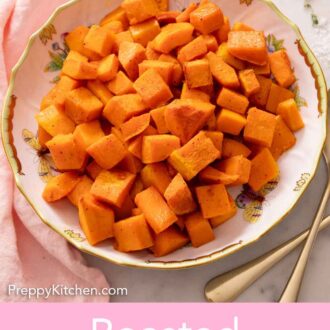 Pinterest graphic of a plate with roasted butternut squash. Pink napkin and some forks beside it.