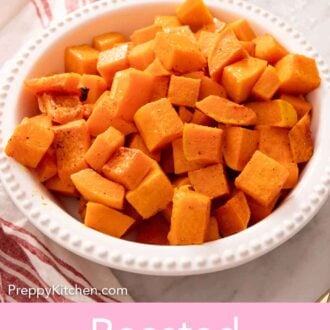 Pinterest graphic of a bowl of roasted butternut squash with a striped napkin beside it.