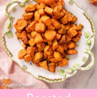 Pinterest graphic of an overhead view of a platter of roasted sweet potatoes. Leaves and a pink linen surrounding it.