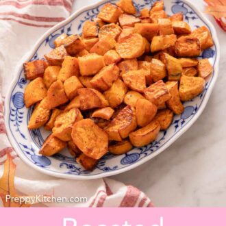 Pinterest graphic of an oval platter of roasted sweet potatoes. Leaves and a linen surrounding it.