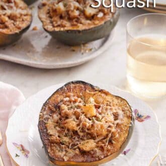 Pinterest graphic of a plate with a stuffed acorn squash with a glass of wine and platter of more squash in the background.