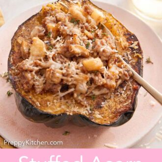 Pinterest graphic of a plate with a serving of stuffed acorn squash with a fork inside. Glass of wine and thyme in the background.