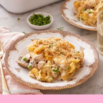 Pinterest graphic of a plate of turkey casserole with a baking dish, bowl of parsley, and a second plated serving in the background.