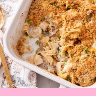 Pinterest graphic of a baking dish of turkey casserole with a serving scooped out.