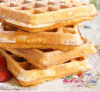 Pinterest graphic of a side view of a stack of waffles with powdered sugar dusted on top.