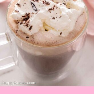 Pinterest graphic of a cup of hot chocolate with whipped cream and shaved chocolate on top.