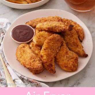 Pinterest graphic of a plate of air fryer chicken tenders with a small bowl of bbq sauce. A bowl of french fries and a pitcher of iced tea in the background.