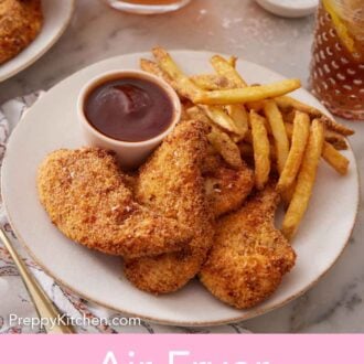 Pinterest graphic of a plate of air fryer chicken tenders with french fries and a small bowl of bqq sauce.