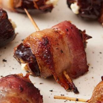 A plate with multiple bacon wrapped dates.