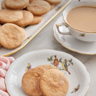 Pinterest graphic of a plate with three biscochitos with a drink in the background with a platter of additional cookies.