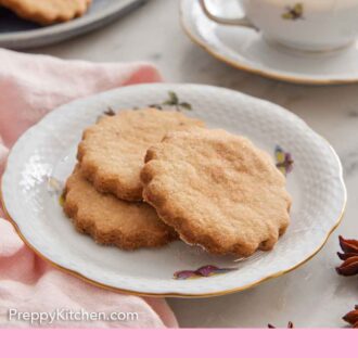 Pinterest graphic of a plate with three biscochitos and a drink in the background.
