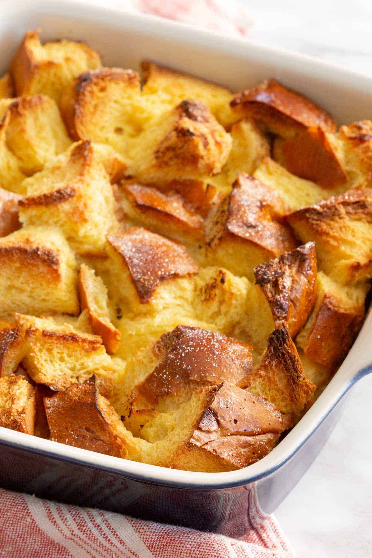 A slightly overhead angled view of a baking dish of bread pudding.