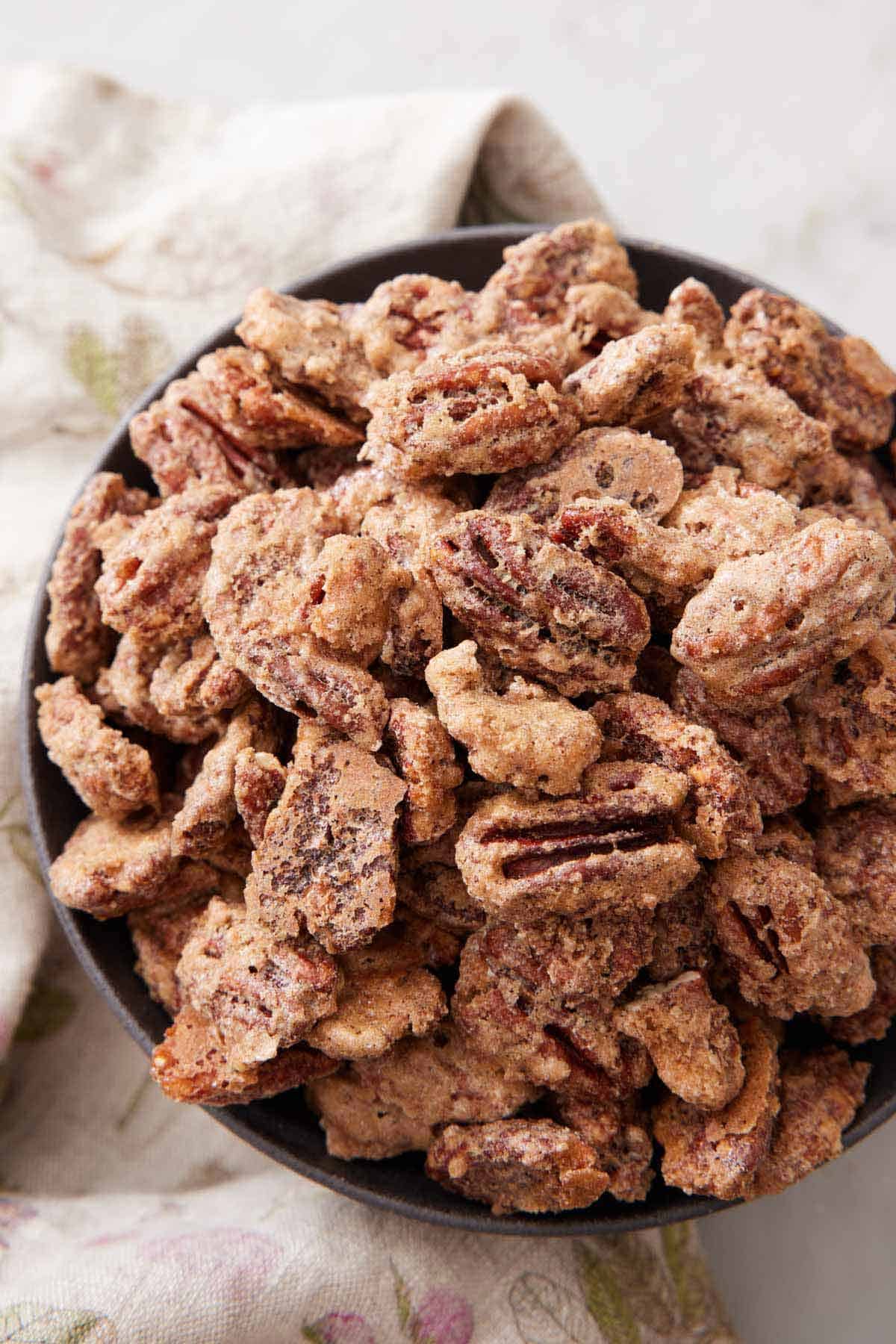 Overhead view of a bowl of candied pecans.