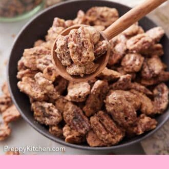 Pinterest graphic of a bowl of candied pecans with a spoonful lifted up.