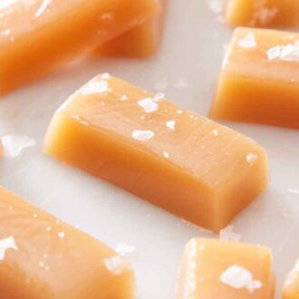 Multiple pieces of caramels topped with sea salt.
